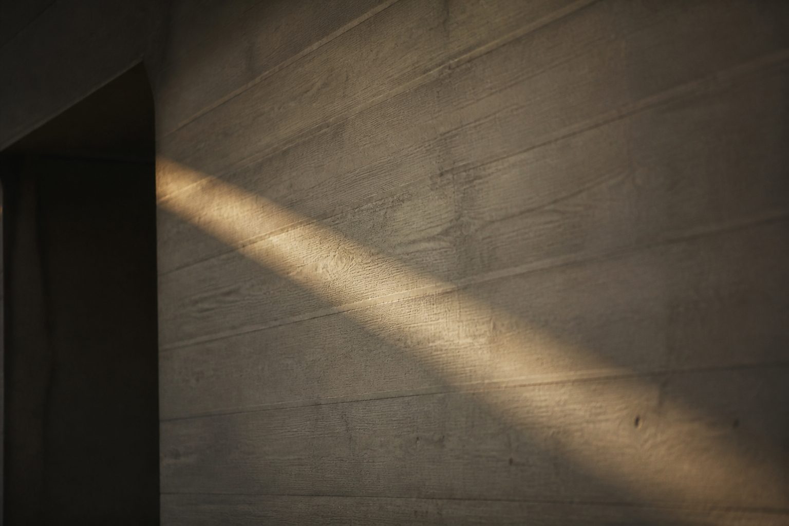 A shaft of light on a concrete wall